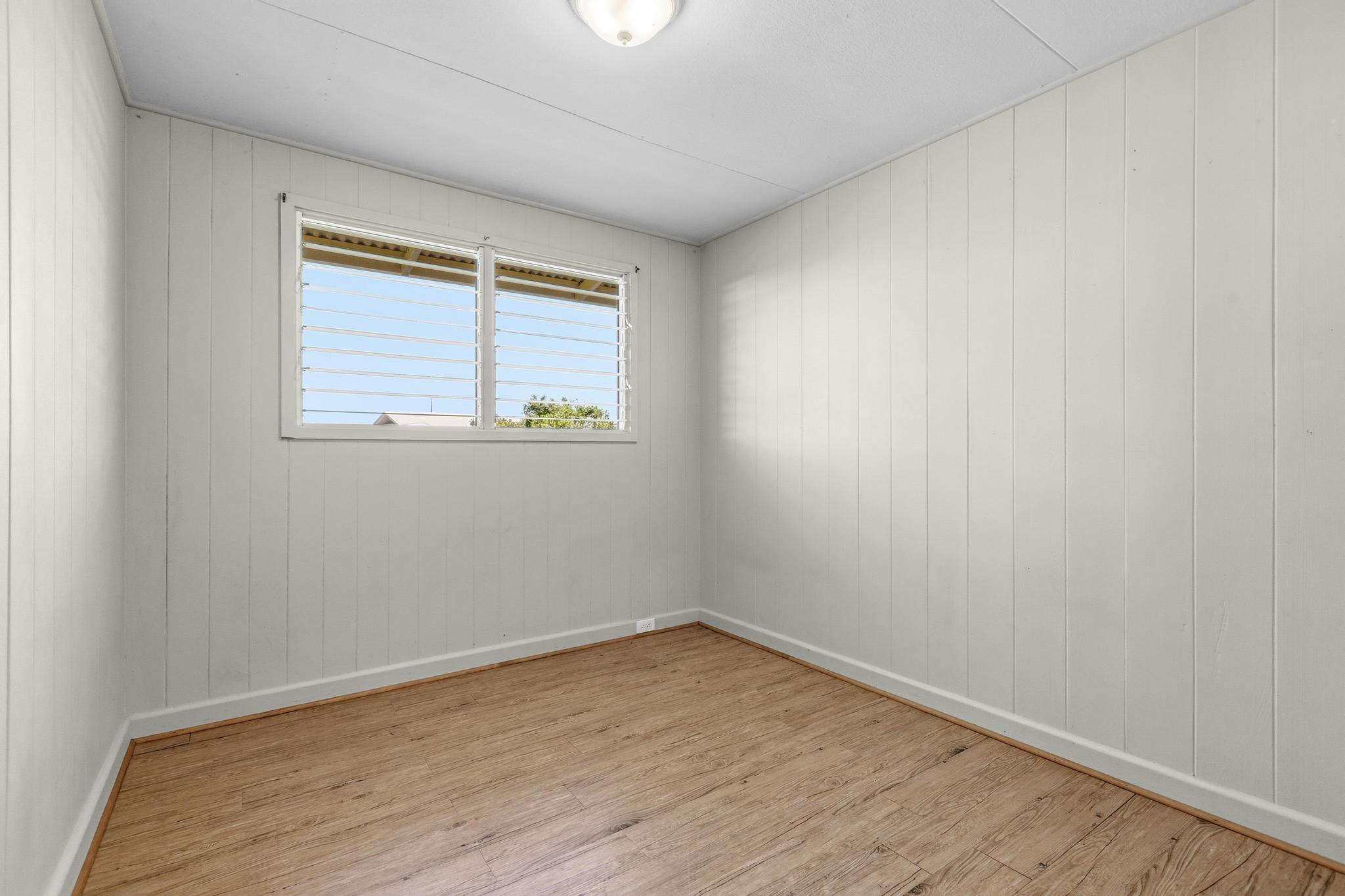 1560 Kilauea Avenue Hilo, HI 96720 - Photo 27 of 29 wooden floor in an empty room with a window