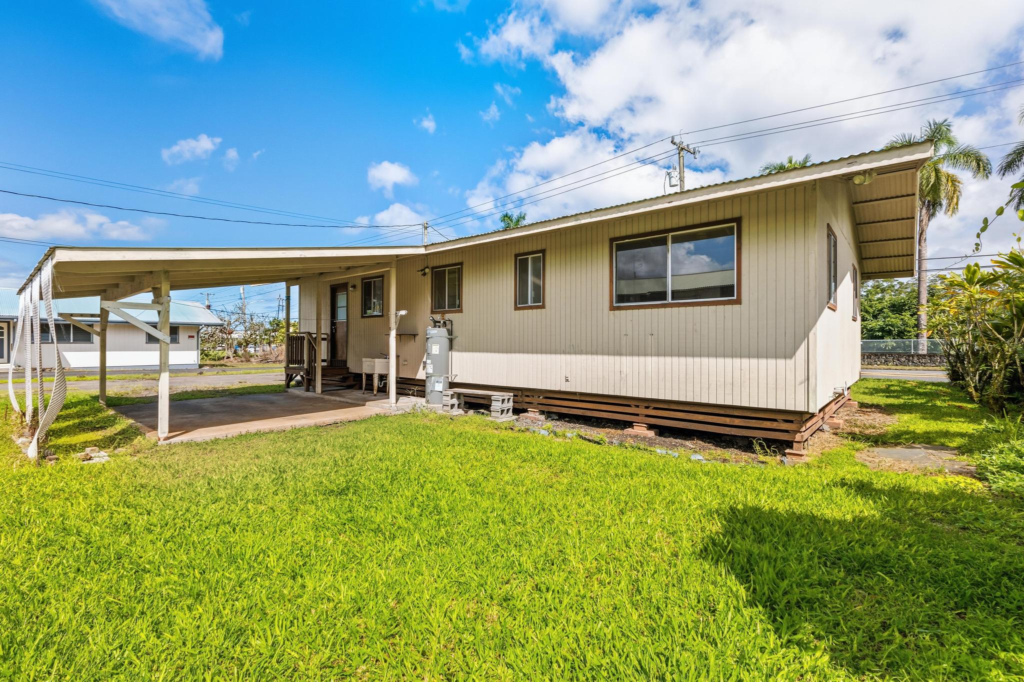 1560 Kilauea Avenue Hilo, HI 96720 - Photo 3 of 29 a backyard of a house with table and chairs