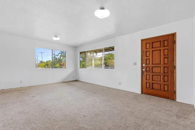 a bathroom with a granite countertop sink a toilet and a mirror