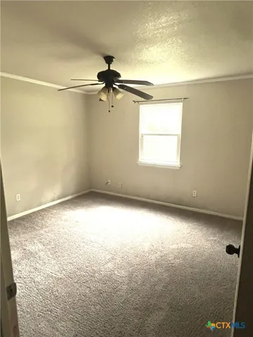 en empty room with windows and ceiling fan view