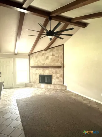 a view of an empty room with a fireplace