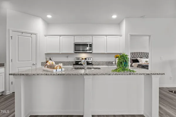 a view of kitchen with furniture and wooden floor