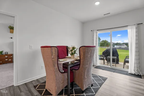 a view of a dining room with furniture wooden floor and windows