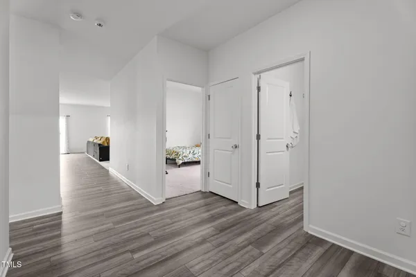 a view of a hallway with wooden floor