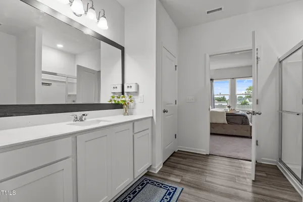 a spacious bathroom with a sink and mirror