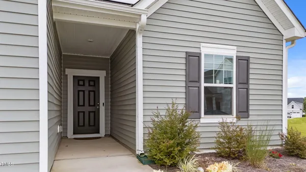 a view of house with backyard