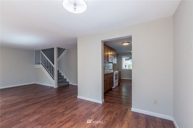 a bathroom with a granite countertop toilet sink and mirror