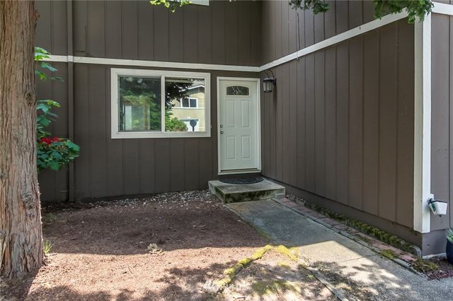 a kitchen with a sink a window and cabinets