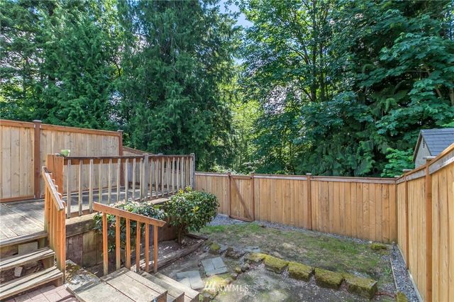 a view of balcony with wooden floor and fence