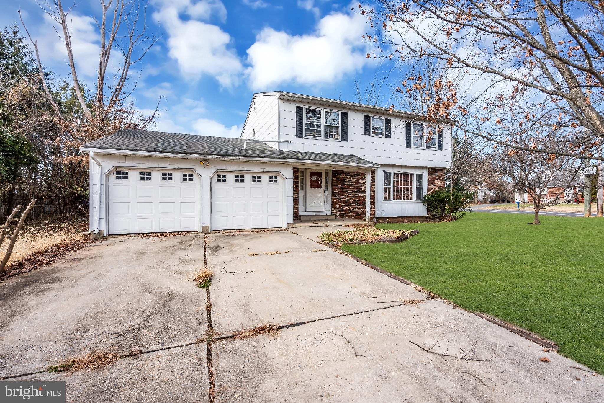 1 Colleen Circle Ewing, NJ 08638 - Photo 6 of 12 a front view of a house with a yard and garage