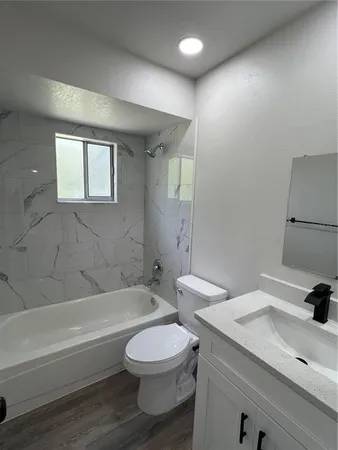 a bathroom with a sink a toilet and a bathtub