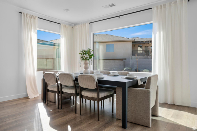382 North Rhyolite Drive, Unit 111 Hurricane, UT 84737 - Photo 32 of 37 Dining area featuring wood-finish flooring and large windows with white sheer curtains