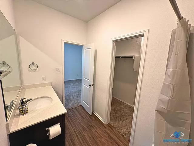 a bathroom with a sink a toilet and mirror