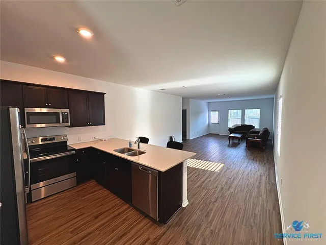 a kitchen with a sink and a stove top oven