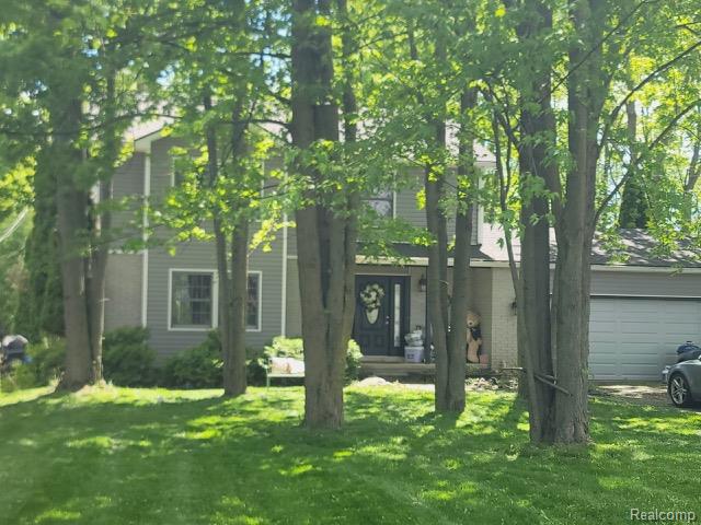 42263 Palmer Road Canton, MI 48188 - Photo 3 of 22 Two-story residence featuring grey horizontal siding and white trim accents
