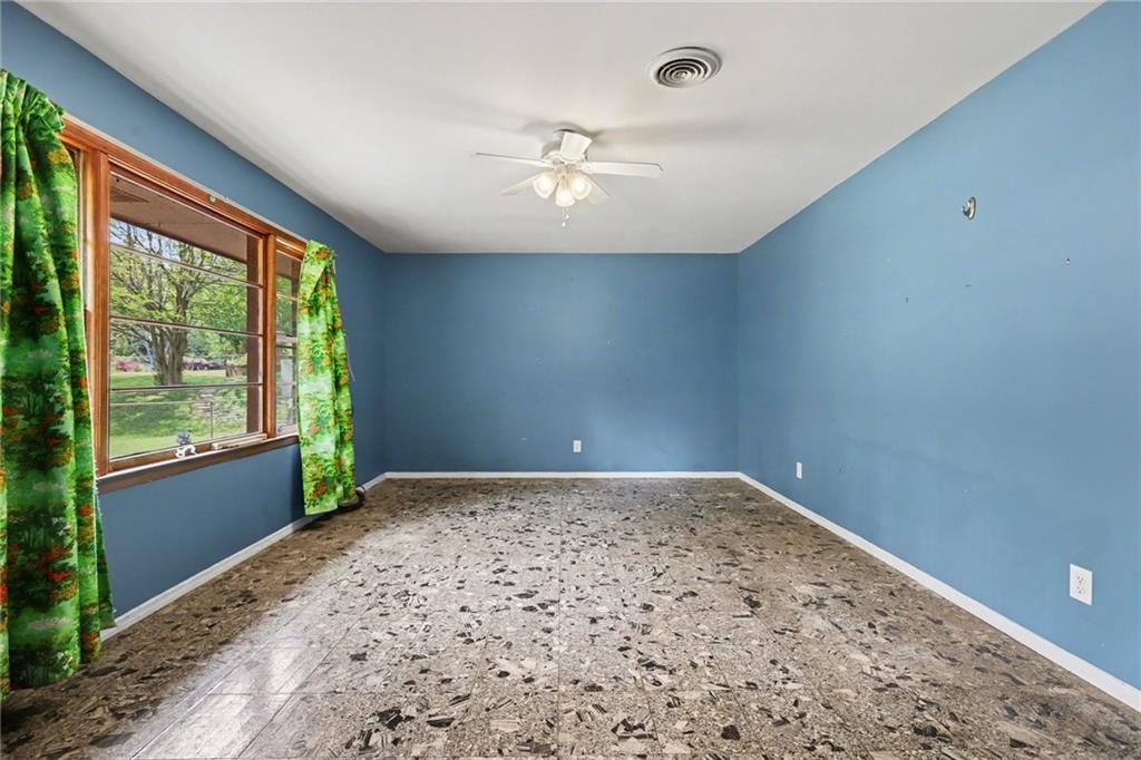 7019 Lake View Lane Doraville, GA 30360 - Photo 7 of 32 an empty room with a window and ceiling fan