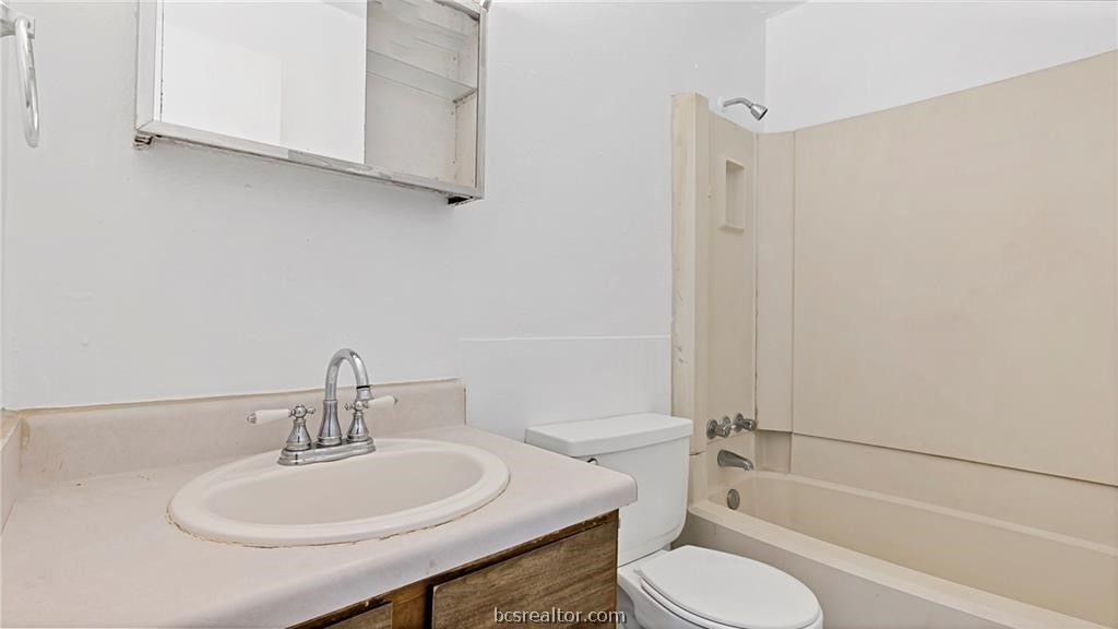 2712 Evergreen Circle Bryan, TX 77801 - Photo 15 of 30 Full bathroom with vanity, bathtub / shower combination, and toilet
