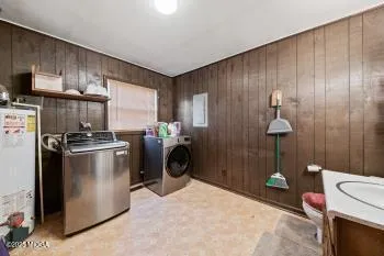 a kitchen with a refrigerator a stove a washer and dryer
