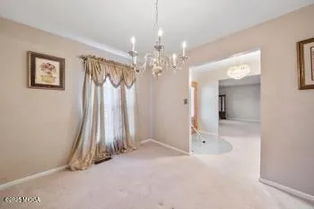 a view of a hallway with chandelier and chandelier
