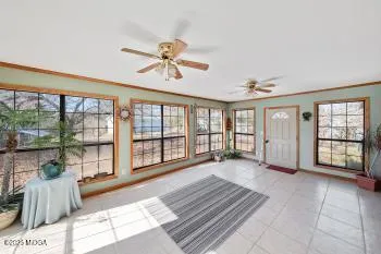a view of a big room with wooden floor and windows