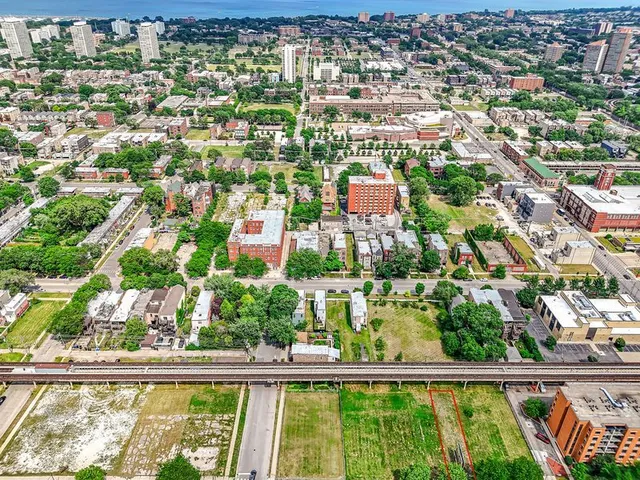 an aerial view of residential building with an outdoor space and seating