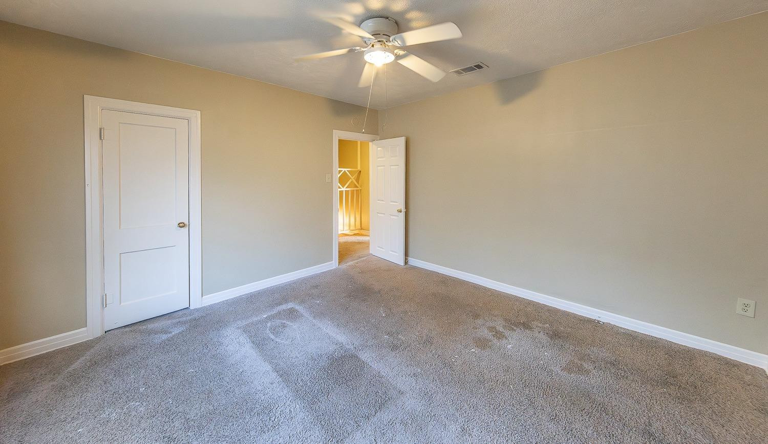 2104 14th Street Lubbock, TX 79401 - Photo 12 of 17 a view of a big room with windows and chandelier fan