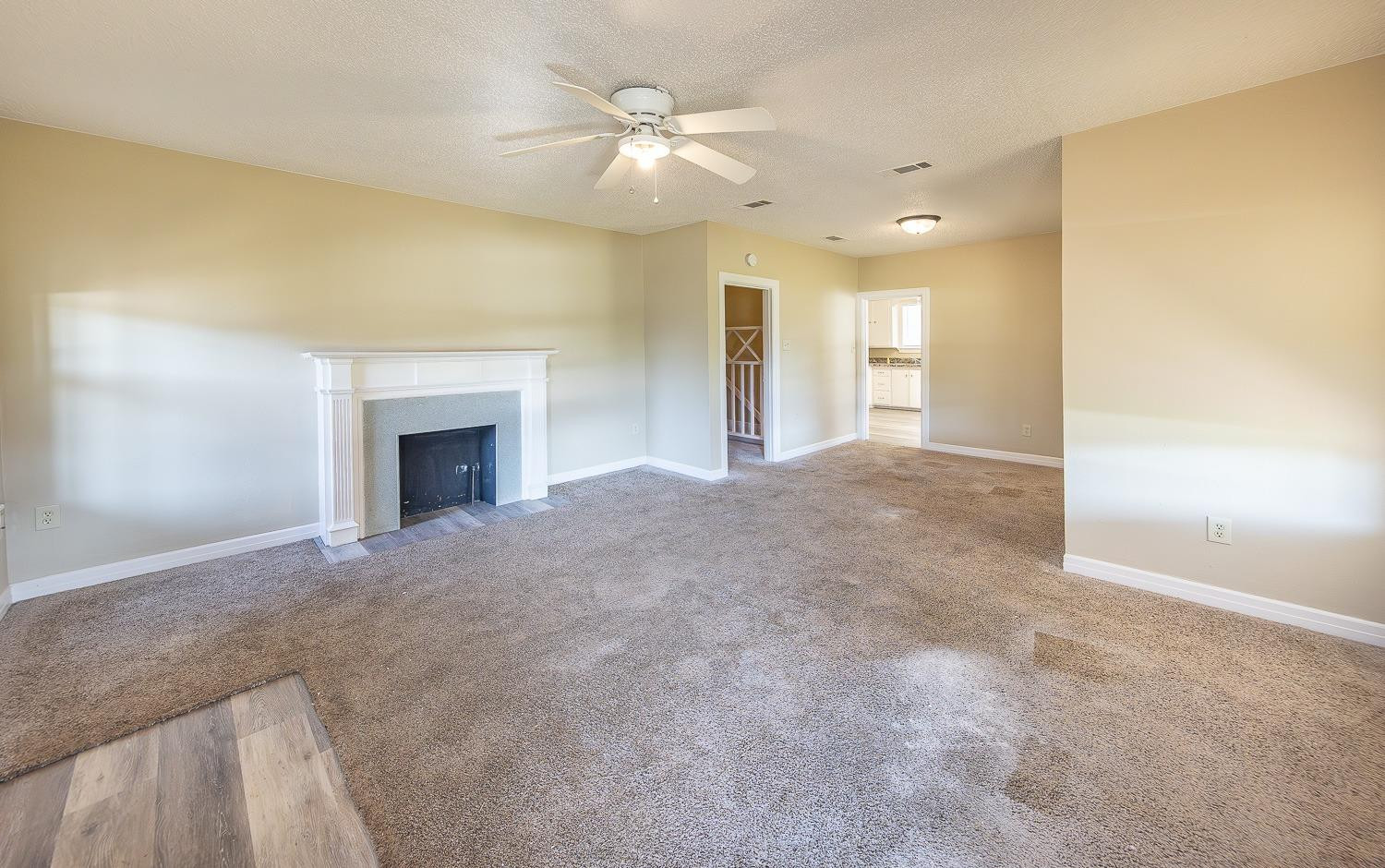 2104 14th Street Lubbock, TX 79401 - Photo 2 of 17 a view of an empty room with a fireplace