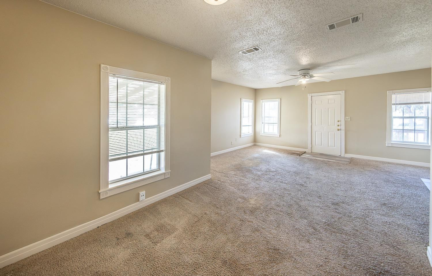 2104 14th Street Lubbock, TX 79401 - Photo 5 of 17 an empty room with windows and closet