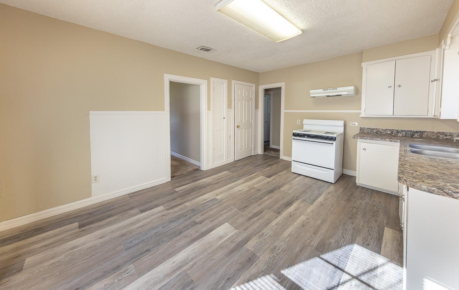 2104 14th Street Lubbock, TX 79401 - Photo 7 of 17 a view of a kitchen with wooden floor