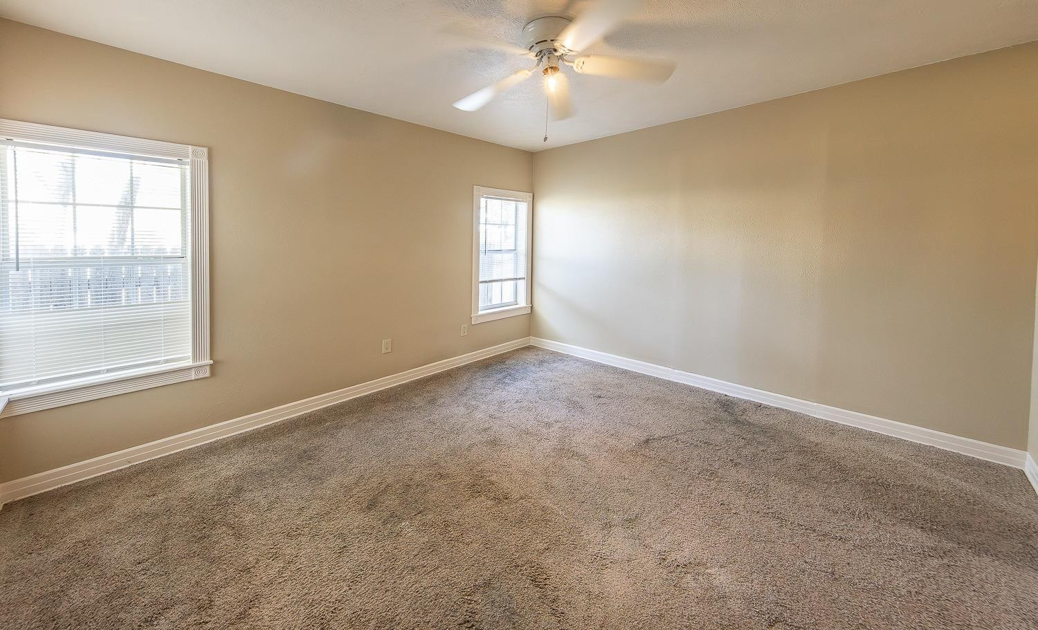 2104 14th Street Lubbock, TX 79401 - Photo 8 of 17 an empty room with windows and fan