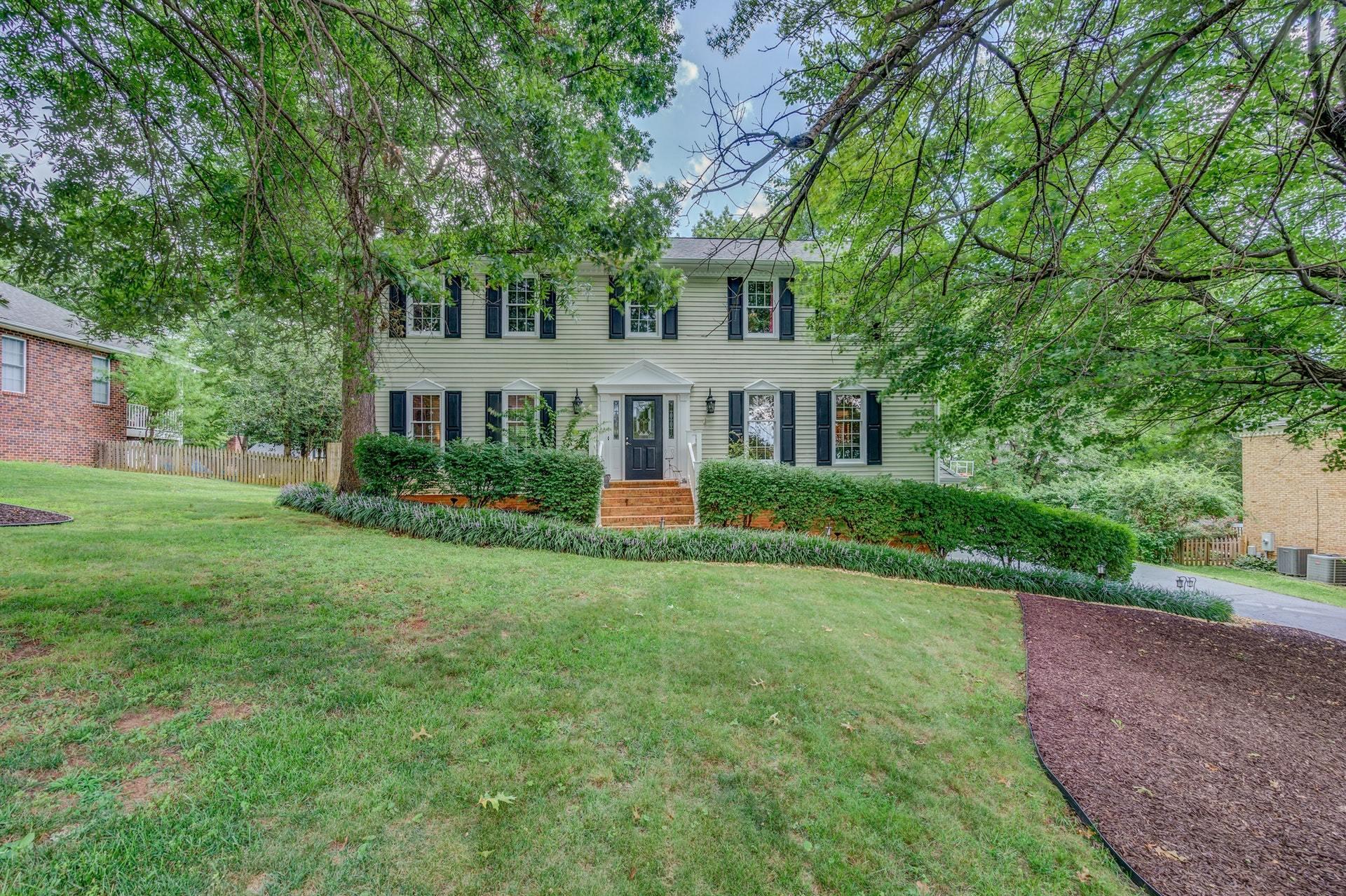 366 Stonehaven Lane Blue Ridge, VA 24064 - Photo 2 of 37 a front view of a house with a yard and trees