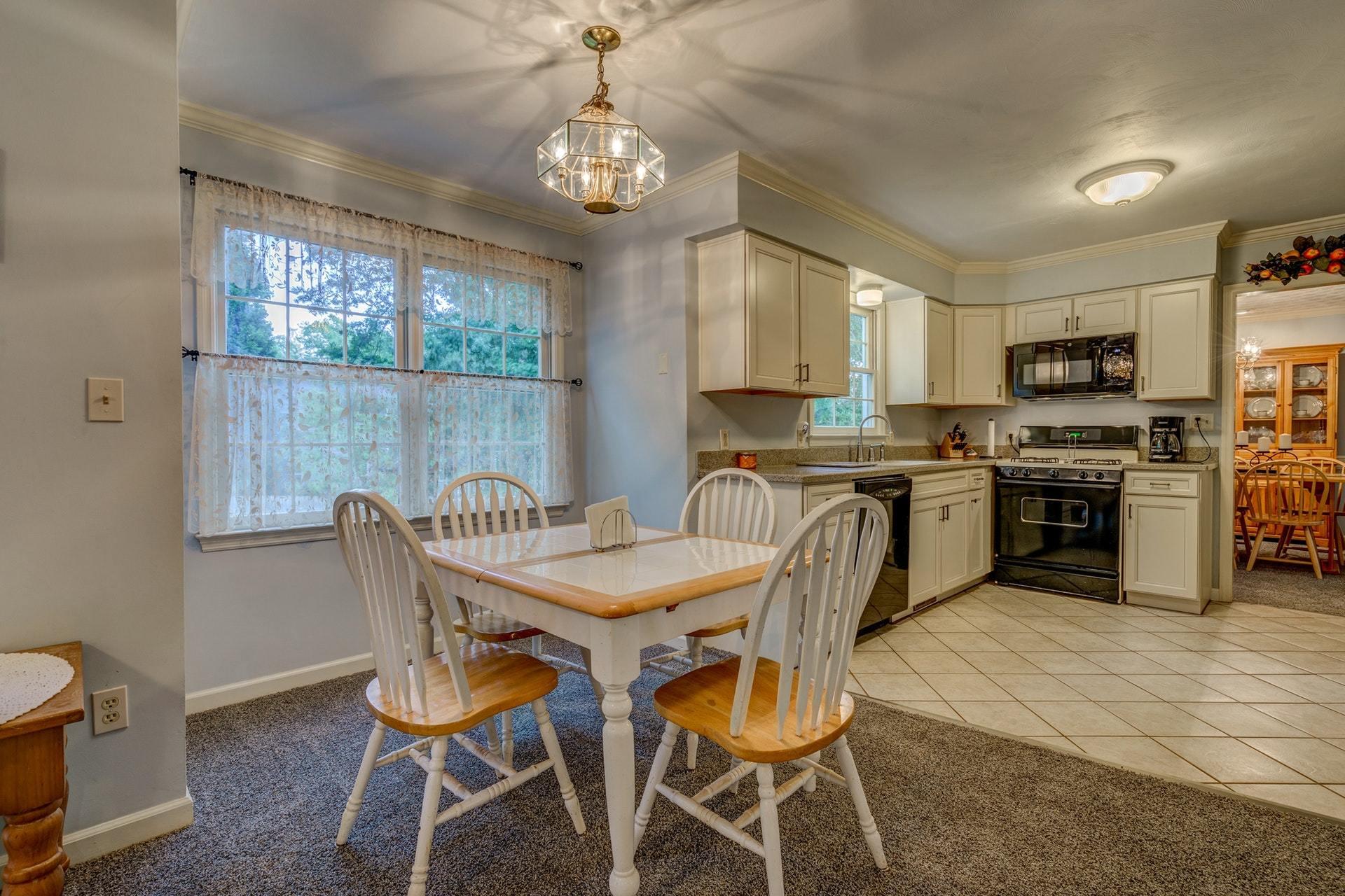 366 Stonehaven Lane Blue Ridge, VA 24064 - Photo 14 of 37 a view of a dining room with furniture a chandelier and kitchen view
