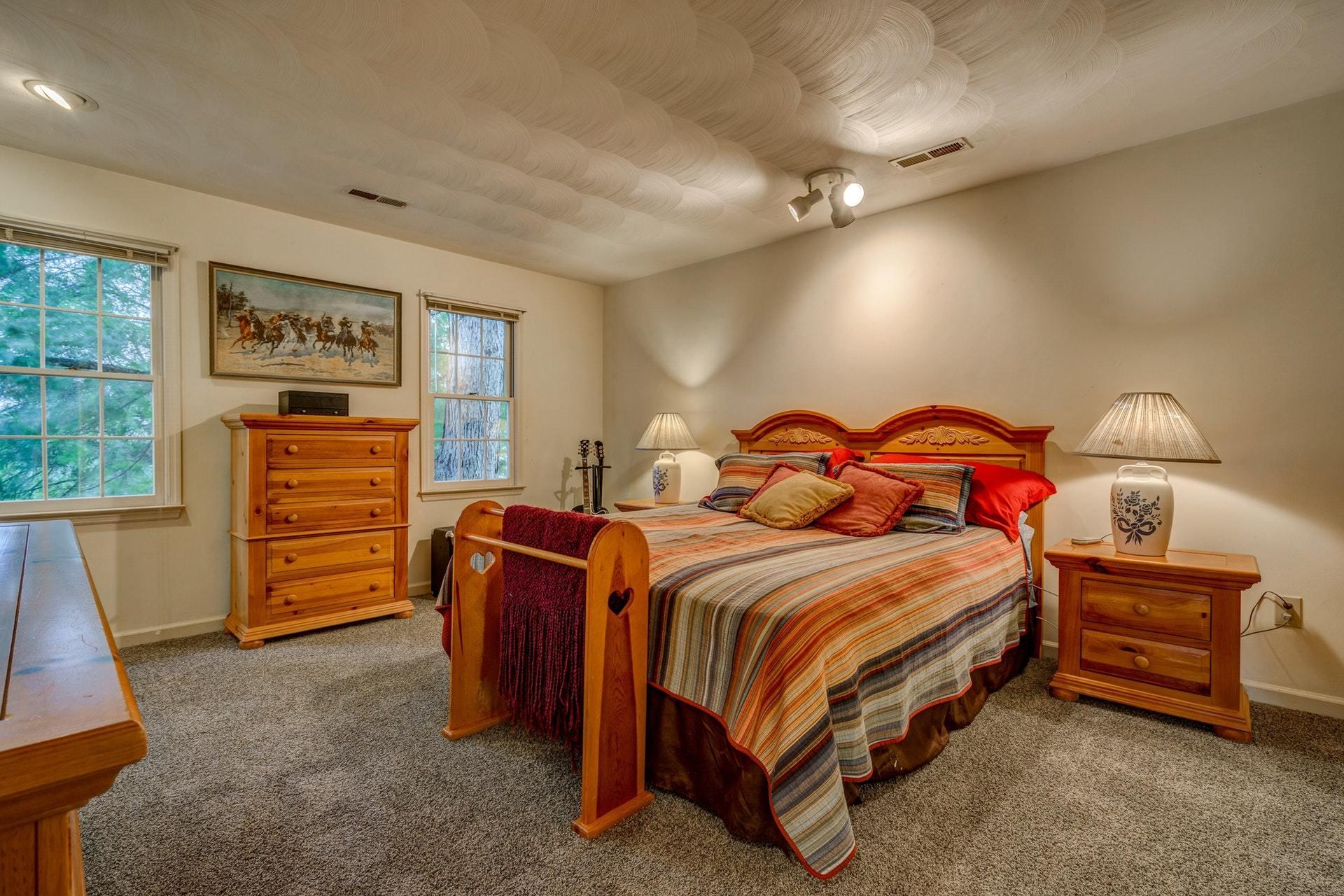 366 Stonehaven Lane Blue Ridge, VA 24064 - Photo 18 of 37 a bedroom with a bed and wooden floor