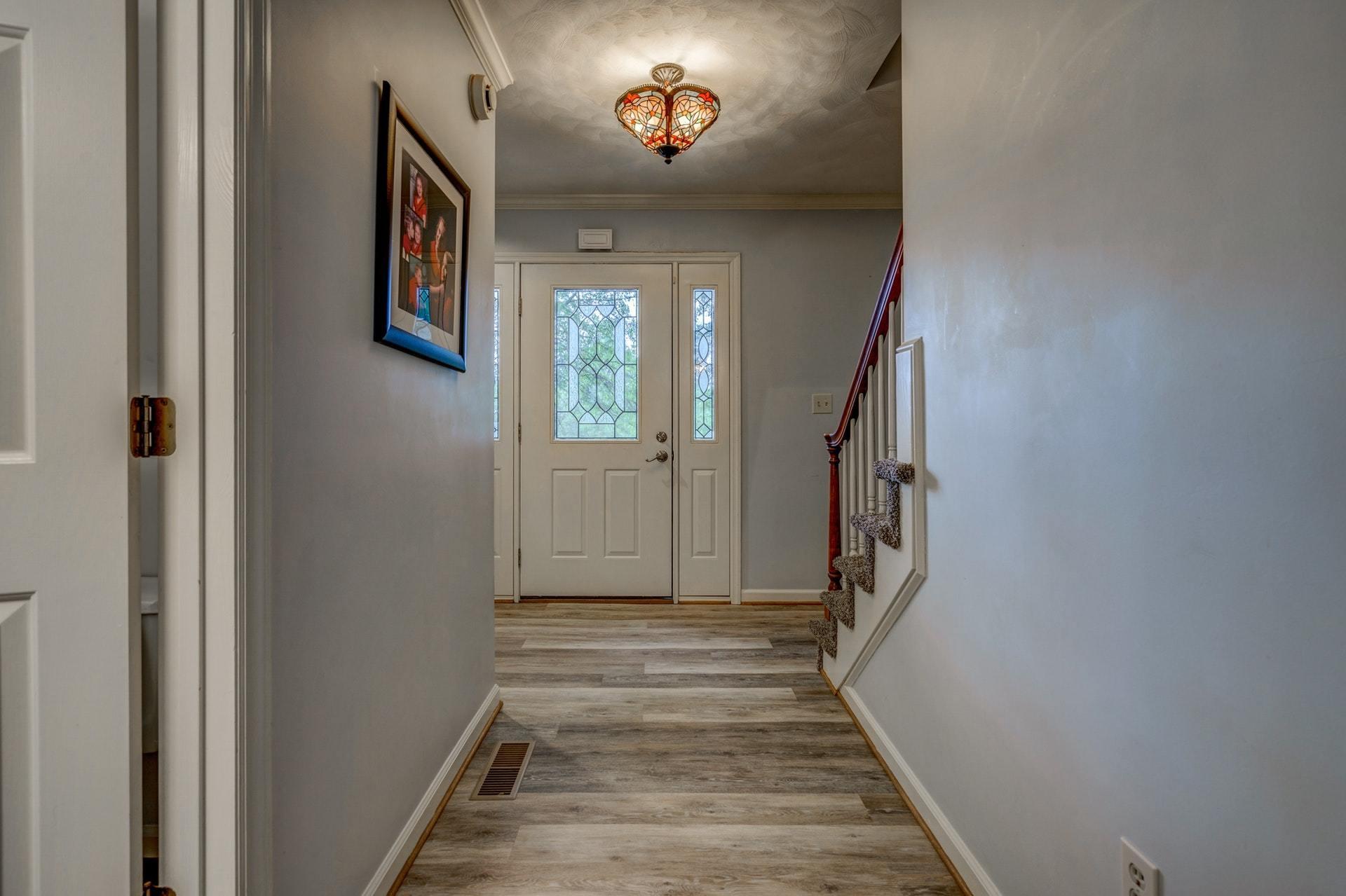 366 Stonehaven Lane Blue Ridge, VA 24064 - Photo 6 of 37 a view of a hallway with wooden floor and stairs