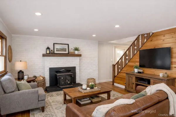 a living room with furniture a flat screen tv and a fireplace