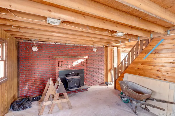 a view of a room with wooden floor and furniture