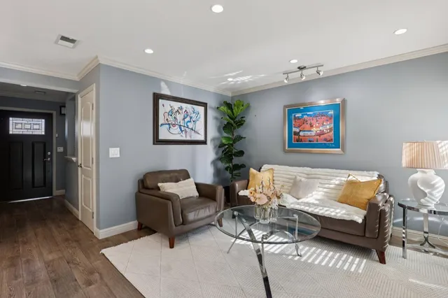 a bedroom with furniture and a wooden floor