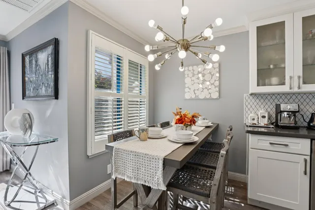 a view of a dining room with furniture and chandelier