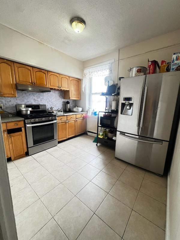 155 Front Street, Unit 2 Secaucus, NJ 07094 - Photo 13 of 19 a kitchen with a refrigerator and a stove top oven