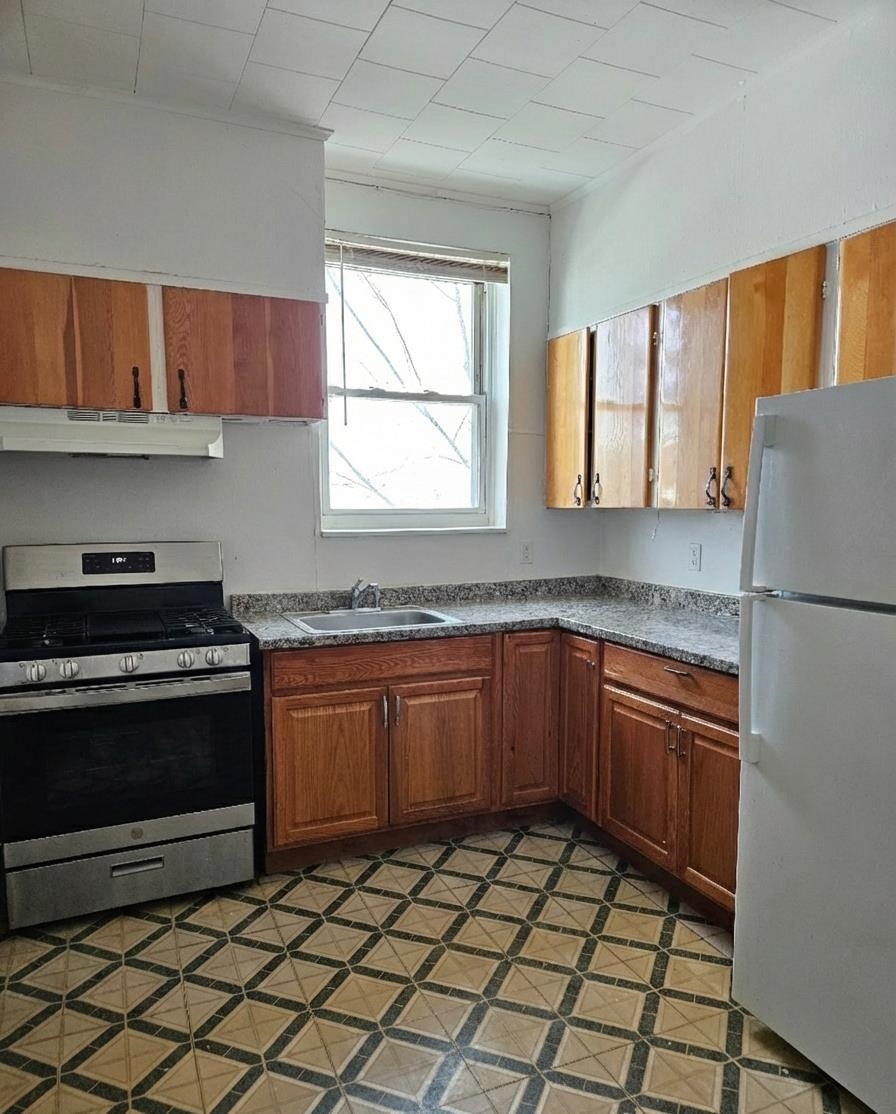 155 Front Street, Unit 3 Secaucus, NJ 07094 - Photo 2 of 27 a kitchen with stainless steel appliances granite countertop a stove a sink and a microwave