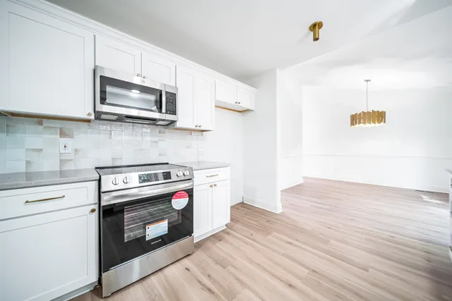 a kitchen with a stove and a microwave