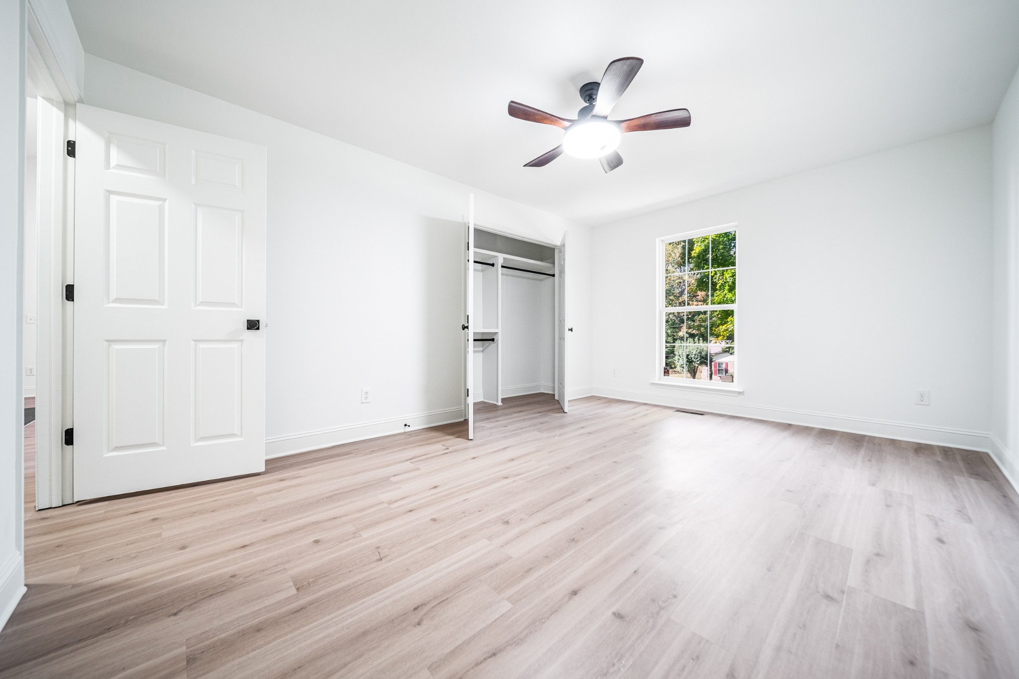 812 Hunters Crossing Lane Springfield, TN 37172 - Photo 20 of 39 an empty room with wooden floor chandelier fan and windows