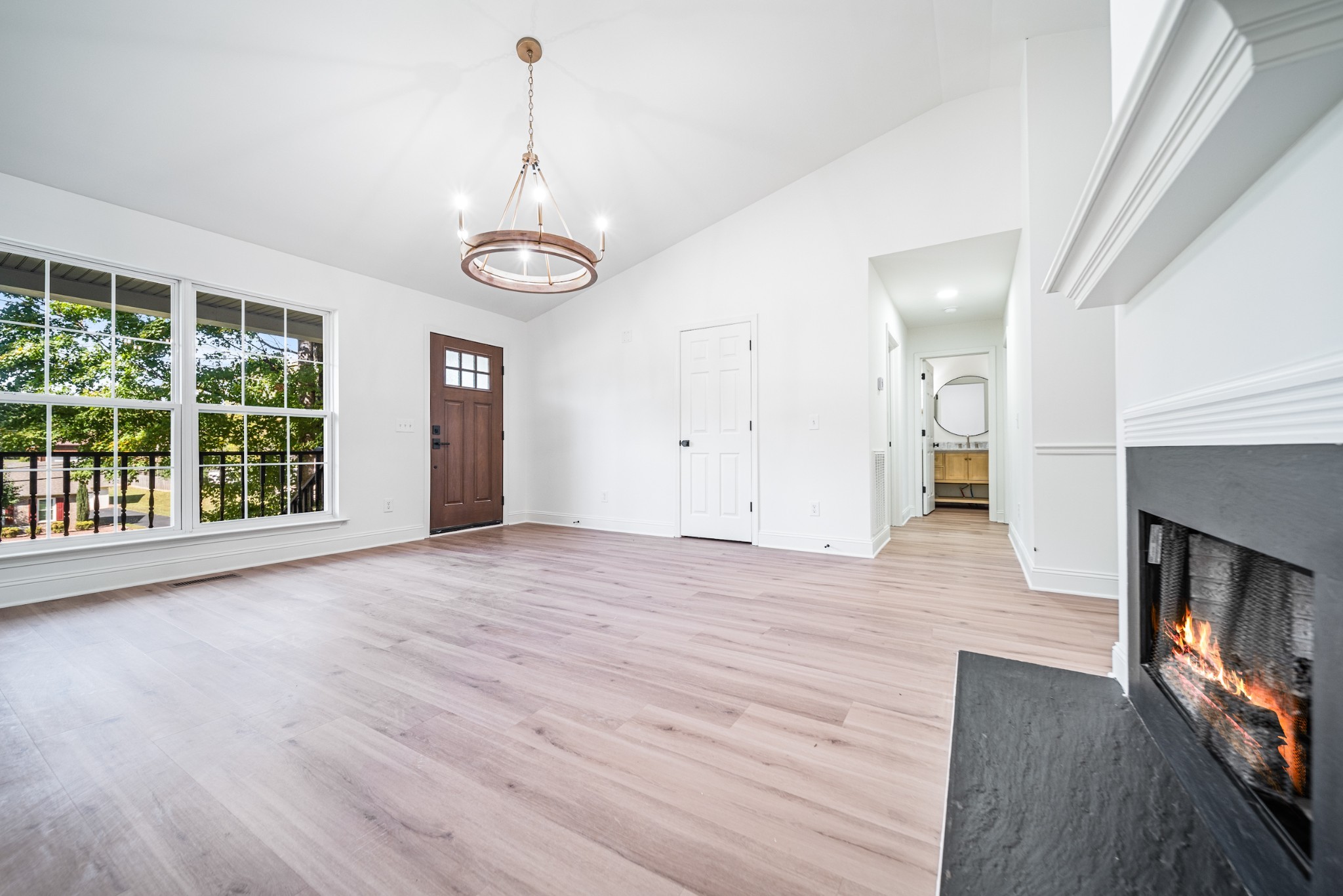 812 Hunters Crossing Lane Springfield, TN 37172 - Photo 2 of 39 an empty room with wooden floor fireplace and windows