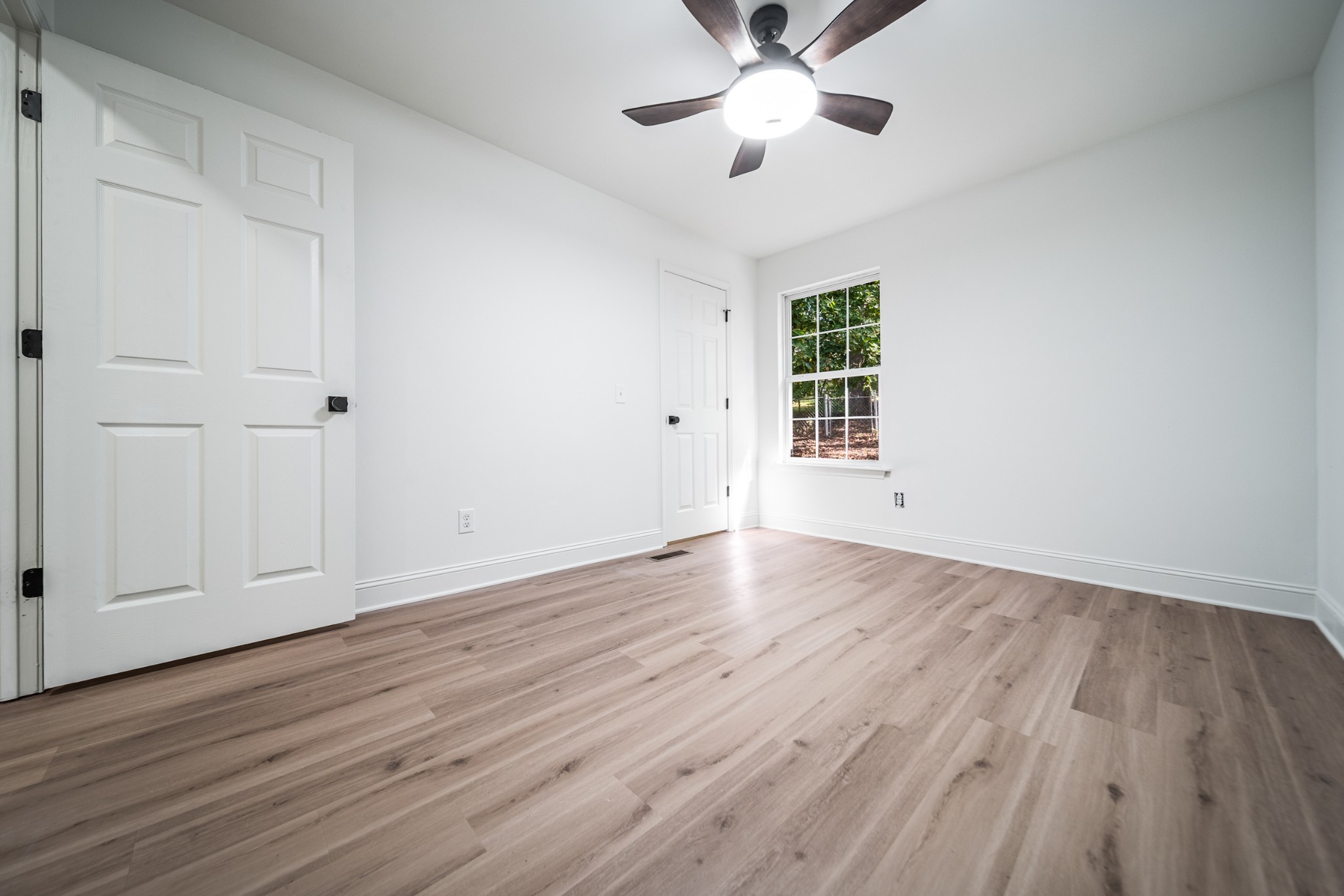812 Hunters Crossing Lane Springfield, TN 37172 - Photo 23 of 39 a view of an empty room with wooden floor and a window