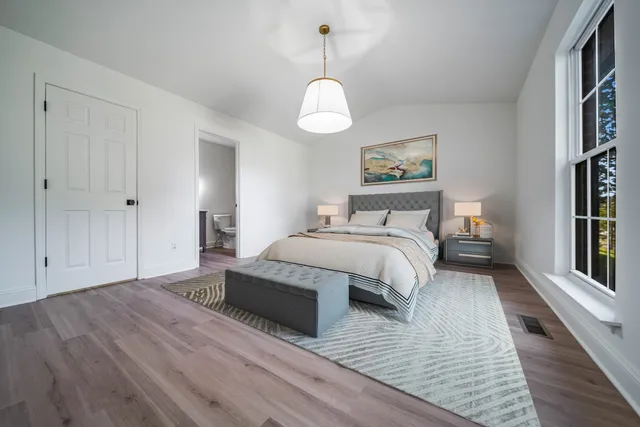 a spacious bedroom with a bed and a window