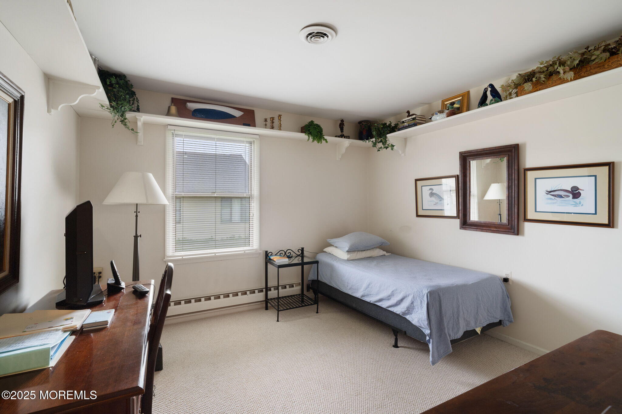 87 Ash Road, Unit 2 Manahawkin, NJ 08050 - Photo 21 of 27 a bedroom with a bed and a desk