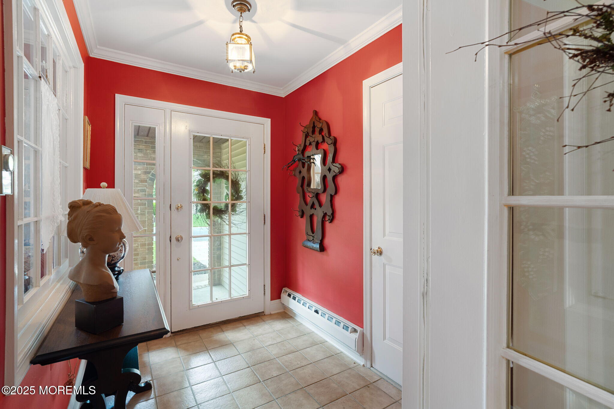 87 Ash Road, Unit 2 Manahawkin, NJ 08050 - Photo 8 of 27 a view of hallway with chandelier