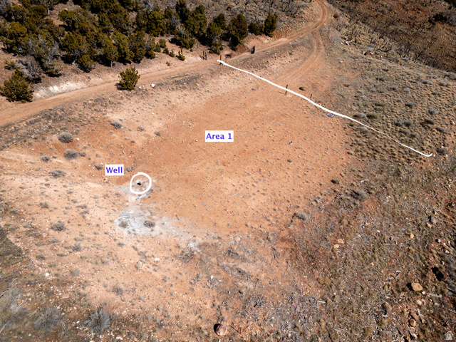 8094 West Red Cloud Loop Road Vernal, UT 84078 - Photo 26 of 35 Aerial view of property and surrounding area with a desert landscape