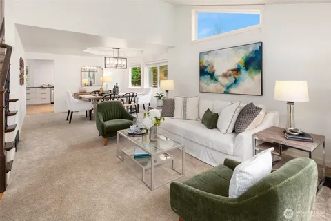 a living room with furniture and a painting on the wall