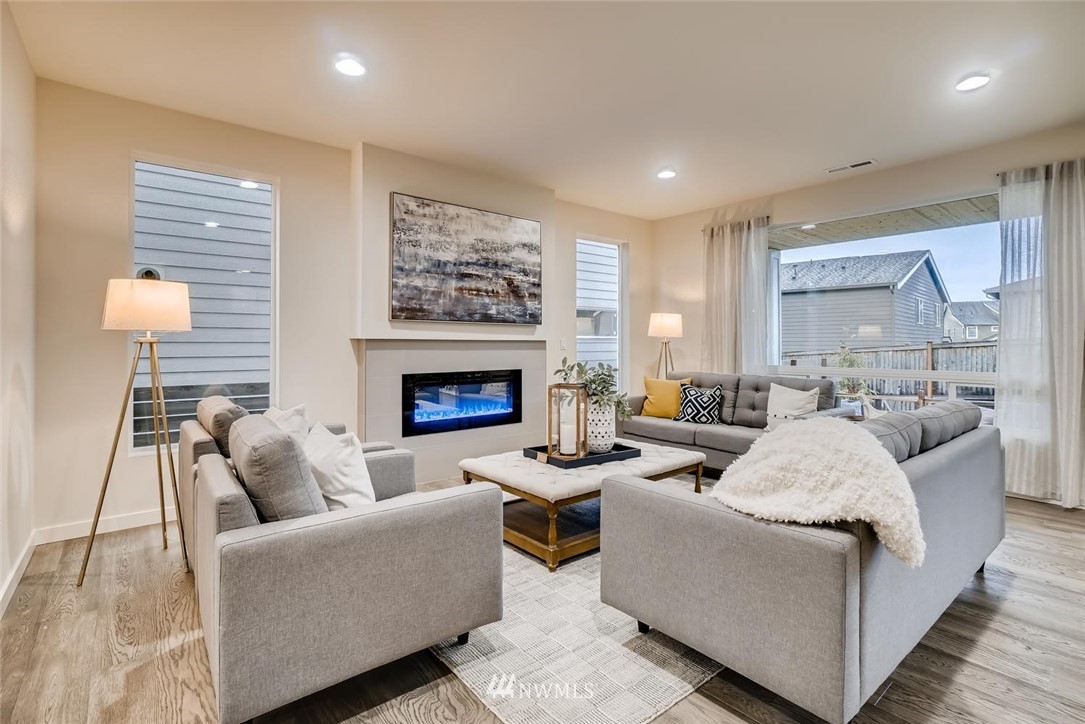 4322 232nd Place Southeast, Unit 5 Bothell, WA 98021 - Photo 22 of 31 a living room with furniture and a fireplace
